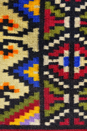 Fragment of antique handmade carpet, Crafts. Woven wool carpet .Folk art.Close up of geometric...