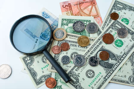 Dollars and magnifying glass. Hundred dollar banknote under magnifying glass.の写真素材