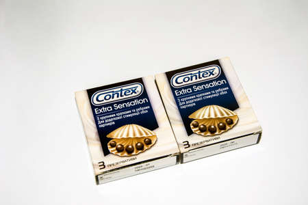 Lviv. Ukraine. February 2021.Contex light condoms on a white background. Condom package in close-up on a white background.Effect additional sensation.の写真素材