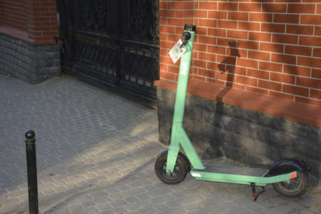 Lviv. Ukraine. May, 2021.rental electric scooters on the city street.Electric scooter economical vehicle in the city for every day.Street view of Lime rental scooters lined up outside of a businessの写真素材