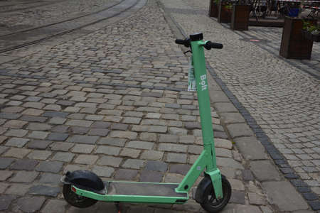 Lviv. Ukraine. May, 2021.rental electric scooters on the city street.Electric scooter economical vehicle in the city for every day.Street view of Lime rental scooters lined up outside of a businessの写真素材