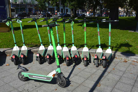 Lviv. Ukraine. May, 2021.rental electric scooters on the city street.Electric scooter economical vehicle in the city for every day.Street view of Lime rental scooters lined up outside of a businessのeditorial素材