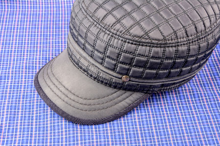 Cap with visor. Winter or autumn accessory for men. Hear wear with canvas or cotton textile on white...
