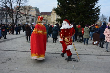 Lviv, Ukraine - December 19, 2021: St. Nicholas on Lviv Christmas fair 2021.St. Nicholas and Santa Claus during mass New Year and Christmas festivities.のeditorial素材