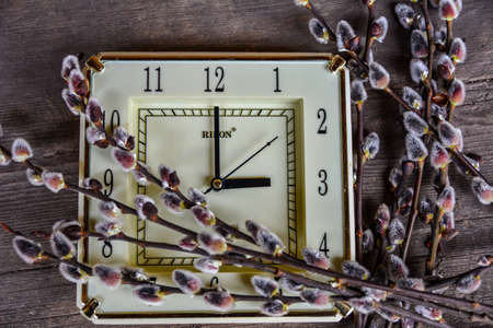 Kiev. Ukraine. March, 2022.Daylight Saving Time (DST). Blue sky with white clouds and clock. Turn time forward (+1h).の写真素材