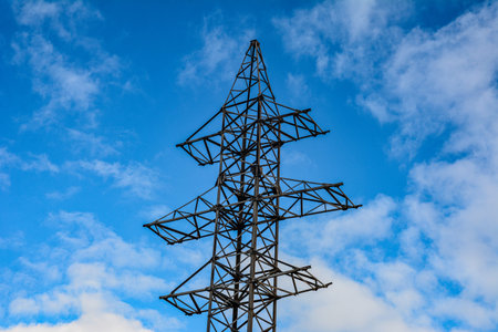 Power Transmission Line .High voltage power lines pylons and electrical cables on a clear blue sky...