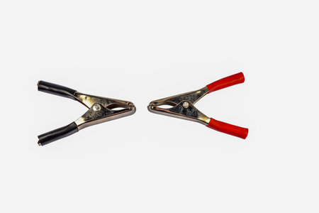 black and red electrical clamps isolated on white background .Electrical connectors with clamps for car jump starter closeup .Terminal wires .の写真素材