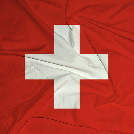 Classic view of the national flag of Switzerland .Flag of Switzerland blowing in the wind.の写真素材