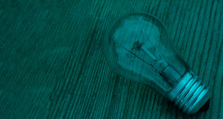 Creative ideas concept for inspiration thinking. Energy saving design of light bulb is growth in the future, with green natural light background textureの写真素材