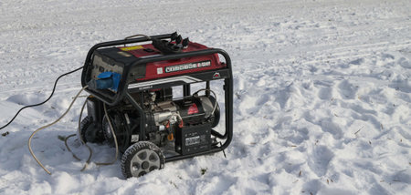 Lviv.Ukraine.Februaru 2023.Usage of gasoline portable outdoor generator, home power generator to...