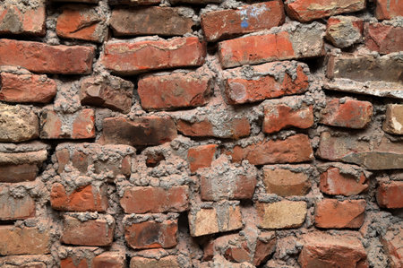 Brick wall background .A Full Frame Background Of A Rough And Textured Brick Wall With Visible Wear And Tare And Copy Space .old red brick wall texture backgroundの写真素材