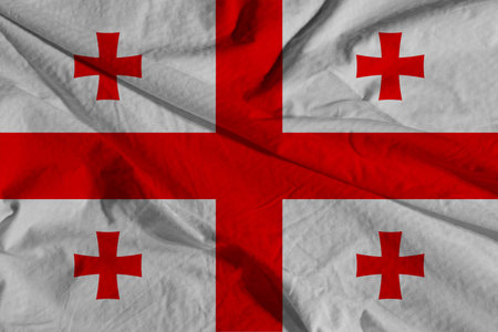 Textured photo of the flag of Georgia.Georgia Flag waving. National flag of Georgia with waves and wind. official colors and proportions.の写真素材