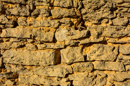 Background of stone wall texture photo.pattern gray color of modern style design decorative uneven cracked real stone wall surface with cement.の写真素材