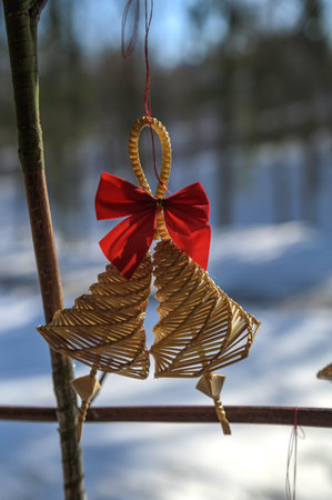 Bell made out of straw.Firewood near the wall for the fireplace.の写真素材