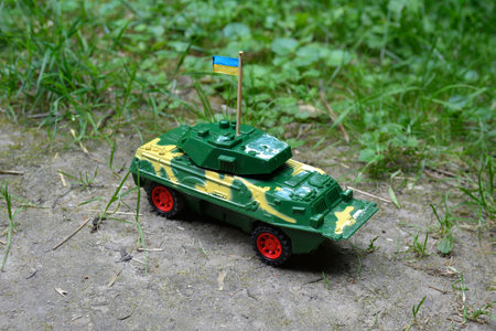 Mini models of armored personnel carriers placed on stand. Kyiv Ukraine.a plastic children's toy armored personnel carrier as a symbol of war in ukraine.の写真素材