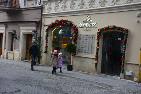 Lviv, Ukraine. January 7, 2023.Street decoration for the Christmas and New Year holidays in rays of sun in Lviv.Lviv during Christmas.Lots of people on the streets.のeditorial素材