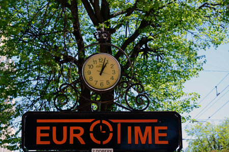 Rivne, Ukraine. A large street clock shows European time.のeditorial素材