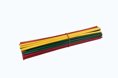 Bundles of natural rye straw dyed in bright colors are prepared for weaving handmade artistic...