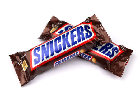 Lviv, Ukraine. January 29, 2024.Editorial illustrative image of snickers chocolate bar with peanuts, caramel and nougat closed up isolated on whiteのeditorial素材