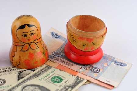 Russian doll with dollars inside isolated on white background.Matryoshka dolls colorful piggy bundle of money.の写真素材