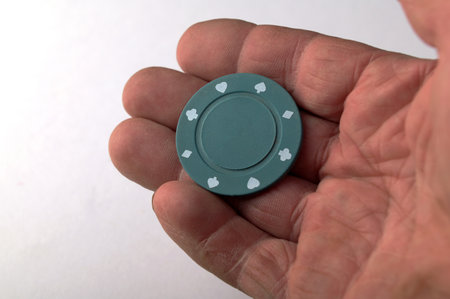 Aces playing cards with a usd 25 casino chip on a white background.a $25 pocket chip with a clean background on the handの写真素材