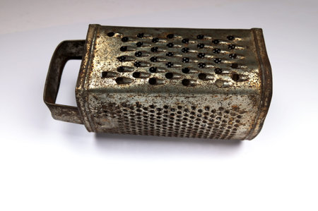 an old metal kitchen grater is old-fashioned and not in demand.の写真素材
