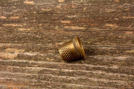 Detail of an old iron thimble with the background out of focusの写真素材