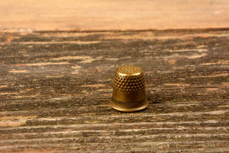 Detail of an old iron thimble with the background out of focusの写真素材