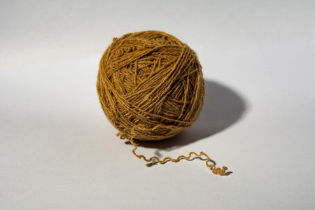woolen thread made of environmentally friendly material, rolled into a ball with an insulated end on...