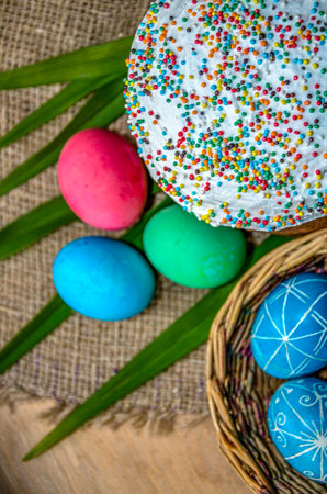 Festive Easter background featuring an Easter bread cake adorned with glaze, chocolate, and eggs. Ideal for an Easter greeting card, ad, promotion, or poster, showcasing a vibrant composition andの写真素材