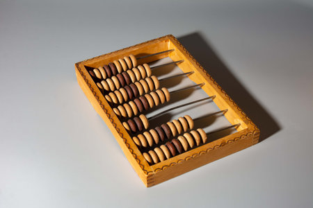 Vintage abacus on a wooden background. A simple mechanical device, a counting board, for performing arithmetic calculations.の写真素材