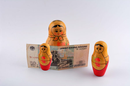Russian Rubles currency banknote and coin in tourism concept with Russian nesting dolls as business financial economic topicの写真素材