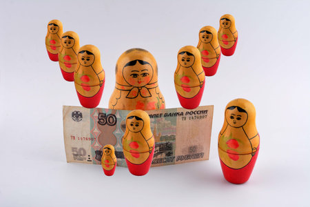 Russian Rubles (RU) currency banknote and coin in tourism concept with Russian nesting dolls as business financial economic topicの写真素材