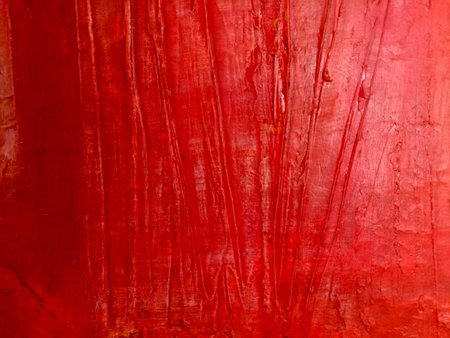 Close-up of an abstract red texture with layered paint and expressive strokes creating a vivid...