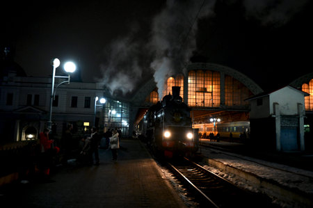 Lviv, Ukraine. February 14, 2026.Vintage steam locomotive with thick smoke at the railway station in...