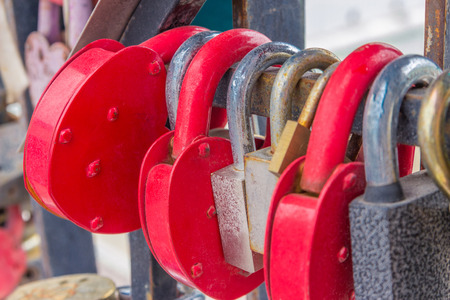 Wedding tradition. The newlyweds close the suspension lock and hang it as a sign of love and devotionの写真素材