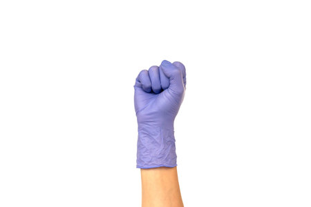 hand in the lilac glove is clenched into a fist. Isolate on white background. Concept of power and...
