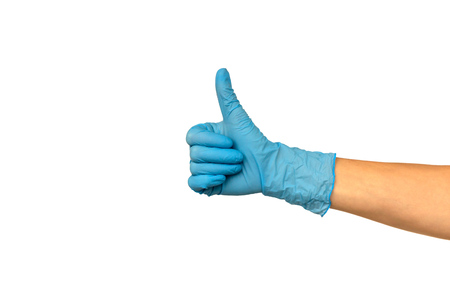 Isolate hand in a blue rubber glove on a white background. Gesture thumb up or like. Concept of successful work of a chef of a surgeon or cleaningの写真素材