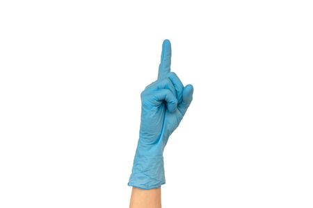 Female hand in a colored rubber glove. Isolate on white background. The concept of the work of a cook in a restaurant or a doctorの写真素材