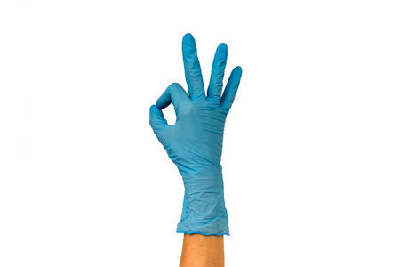 Female hand in blue glove shows gesture ok. Isolate on white background. Gesture means everything is good. The concept of a successful cleaning firmの写真素材