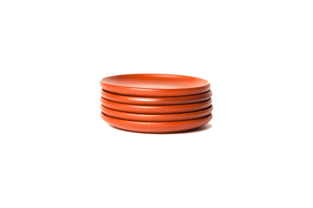 Stack of brown clay plates. The concept of tea ceremony, breakfast, teaの写真素材