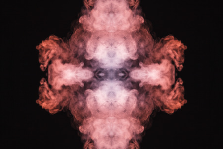 Abstract thick colored smoke on a black background with a monster face. The concept of a light laser show at a musical concert and a print on a T-shirtの写真素材