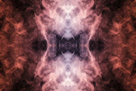 Abstract thick colored smoke on a black background with a monster face. The concept of a light laser show at a musical concert and a print on a T-shirtの写真素材