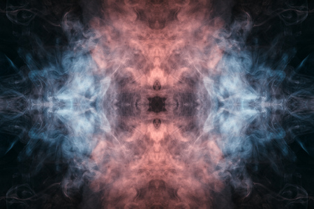 Abstract thick colored smoke blue and pinl colour on a black background with a monster face. The concept of a light laser show at a musical concert and a print on a T-shirtの写真素材