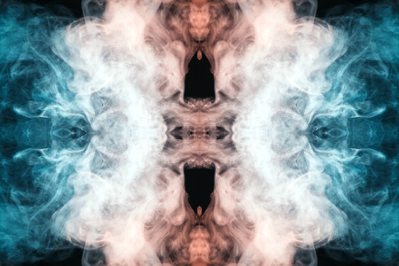 Abstract thick colored smoke blue and pinl colour on a black background with a monster face. The concept of a light laser show at a musical concert and a print on a T-shirtの写真素材