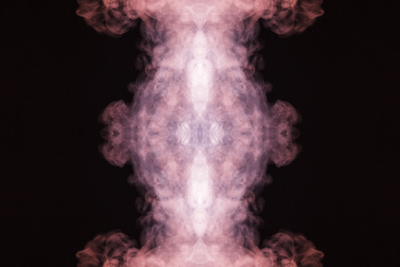 Abstract thick colored smoke on a black background with a monster face. The concept of a light laser show at a musical concert and a print on a T-shirtの写真素材
