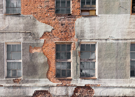 Destroyed building, red brick, gray concrete, window with old wooden frames. Concept textural...
