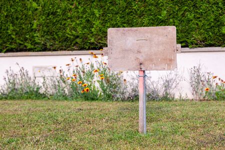 Rectangular stone plate against background of ivy wall. Empty sign board with border, frame. Concept framework, place for text, plate with copyspaceの写真素材