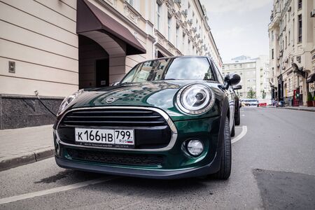 Russia Moscow 2019-06-17 Green car Mini Cooper is parked on a street of a European city. Concept travel in Europe together on compact fashionable car.のeditorial素材