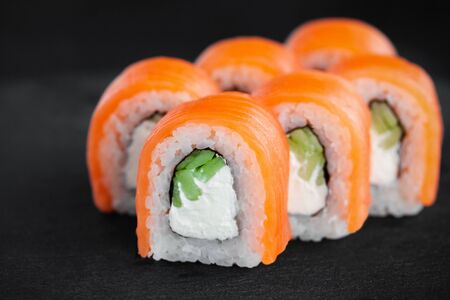 Portion of fresh philadelphia sushi roll on black backgroundの写真素材